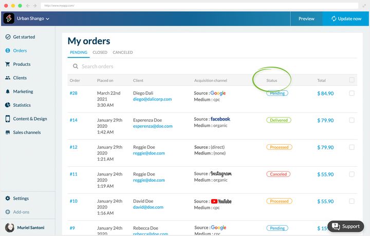 The back office order list, open on the tab of orders in progress, next to the one for closed orders and the one for cancellations. Under a search field, a table gives for each order its number, its date and time, the customer with their email address, the channel they came through, its status in a coloured chip, circled here, and its amount. A checkbox closes each row.